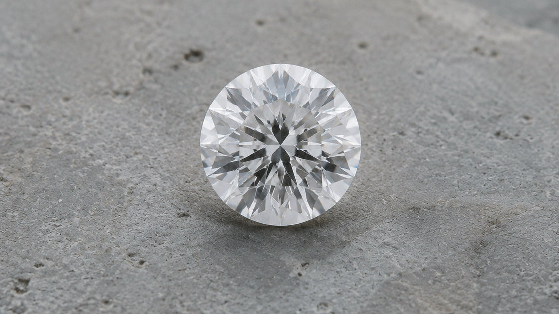 A lab-grown diamond resting on a concrete surface — DHARIN