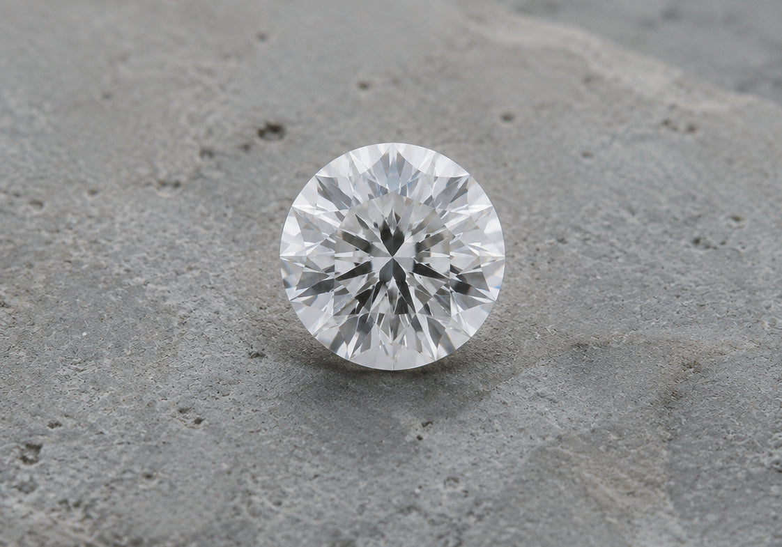 A lab-grown diamond resting on a concrete surface — DHARIN