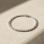 DHARIN Mixed-Cut Tennis Bracelet - macro detail, round brilliant and emerald-cut diamonds alternating