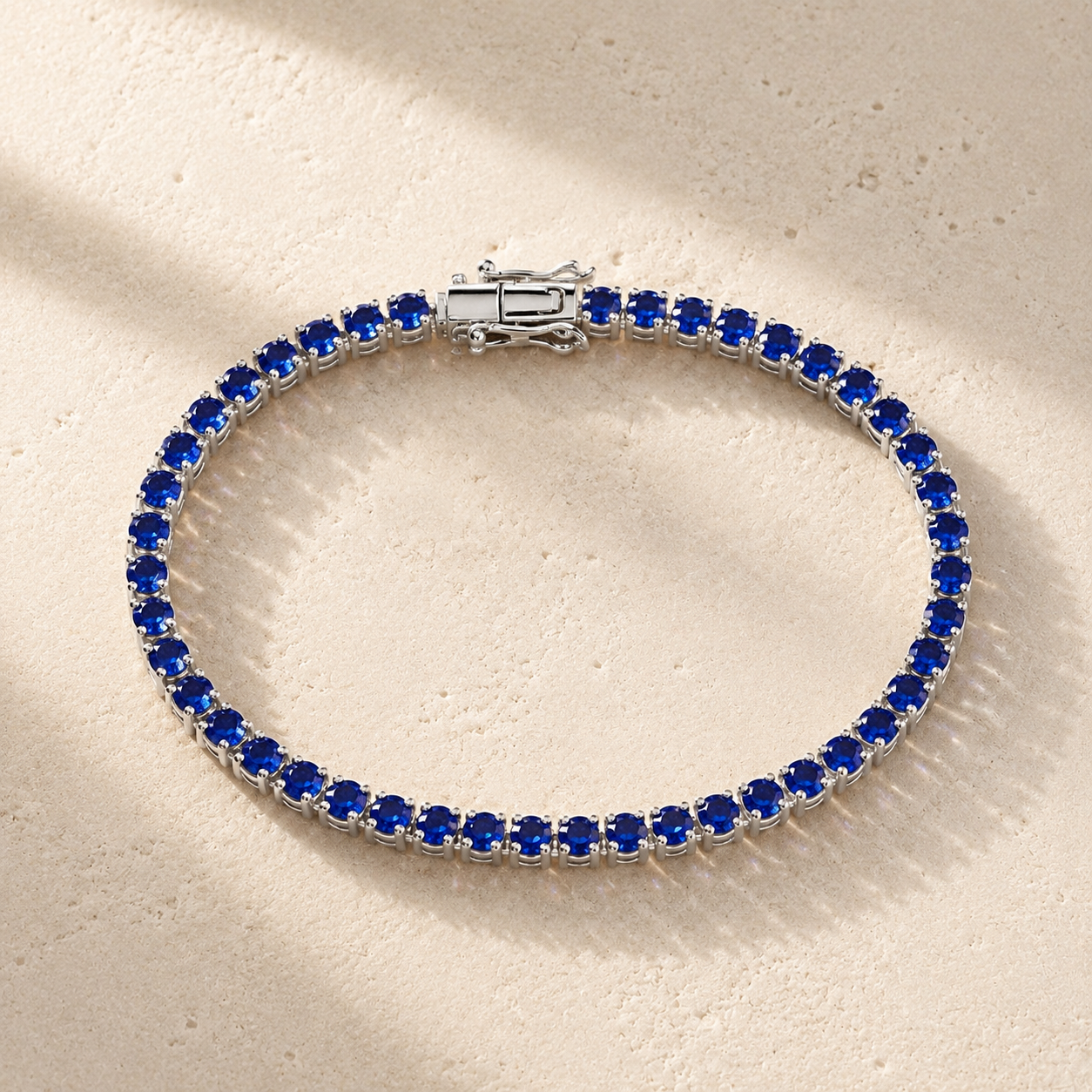 DHARIN Blue Sapphire Tennis Bracelet - S925 silver, continuous row lab-grown sapphires, flat lay overhead