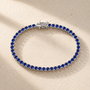 DHARIN Blue Sapphire Tennis Bracelet - S925 silver, continuous row lab-grown sapphires, flat lay overhead