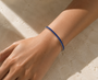 DHARIN Blue Sapphire Tennis Bracelet - 45 degree view, continuous sapphire row, sterling silver