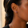 DHARIN Ruby Halo Stud Earrings - ear wearing lifestyle, vivid red ruby on earlobe, quiet luxury