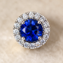 DHARIN Blue Sapphire Halo Stud Earrings - ear wearing lifestyle view, sapphire vivid on earlobe