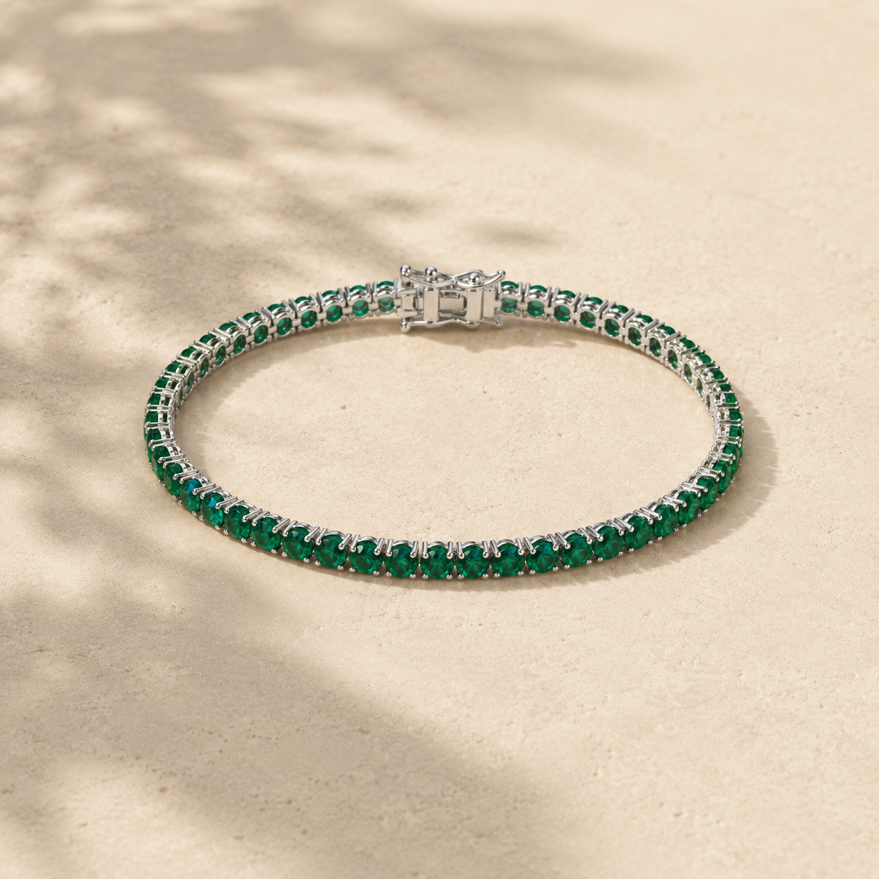 DHARIN Emerald Tennis Bracelet - S925 silver, continuous row lab-grown emeralds, flat lay overhead