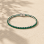 DHARIN Emerald Tennis Bracelet - S925 silver, continuous row lab-grown emeralds, flat lay overhead