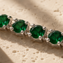 DHARIN Emerald Tennis Bracelet - macro detail, round lab-grown emeralds, four-claw setting