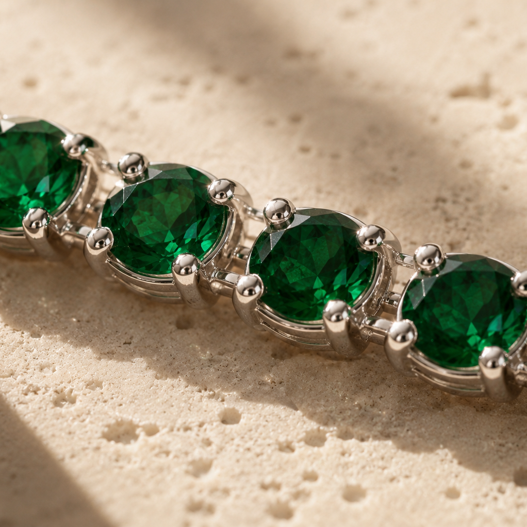 DHARIN Emerald Tennis Bracelet - macro detail, round lab-grown emeralds, four-claw setting