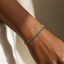 DHARIN Emerald Tennis Bracelet - 45 degree view, continuous emerald row, sterling silver