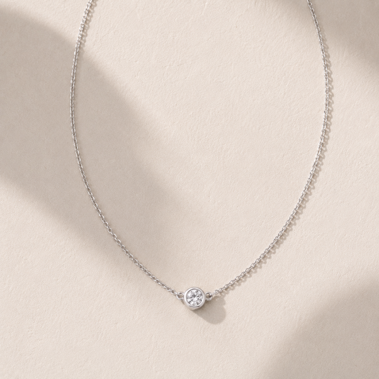 DHARIN Solitaire Floating Diamond Pendant - flat lay overhead, bezel setting sterling silver