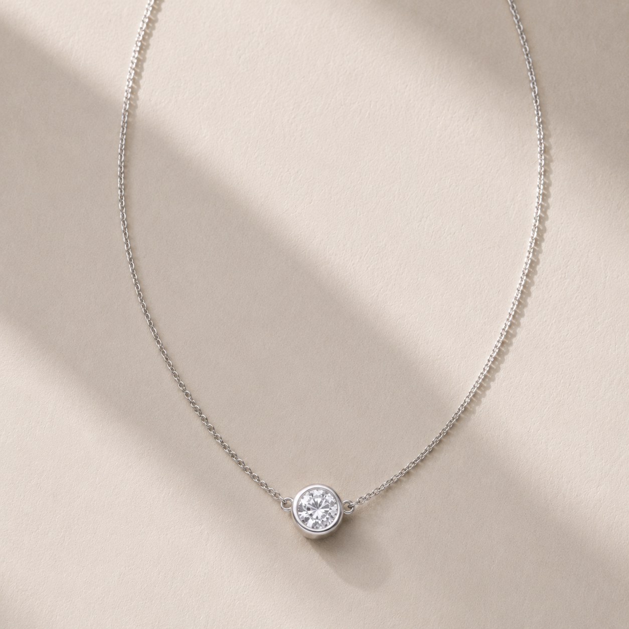 DHARIN Solitaire Floating Diamond Pendant - editorial environment shot, limestone surface