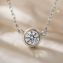 DHARIN Solitaire Floating Diamond Pendant - 45 degree view, round brilliant diamond bezel pendant