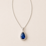 DHARIN Teardrop Gemstone Pendant - blue sapphire and emerald, two-color comparison, limestone surface