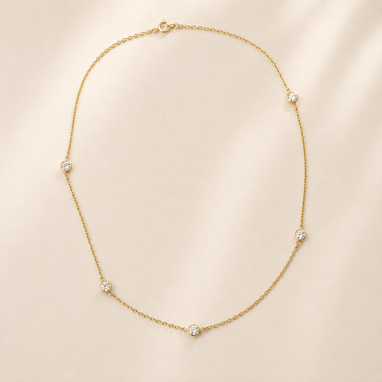 DHARIN Station Diamond Layering Necklace - flat lay overhead, 5 diamonds uneven intervals, 18K gold vermeil