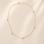 DHARIN Station Diamond Layering Necklace - flat lay overhead, 5 diamonds uneven intervals, 18K gold vermeil