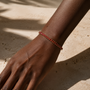 DHARIN Ruby Tennis Bracelet - lifestyle wrist view, ruby red tennis bracelet