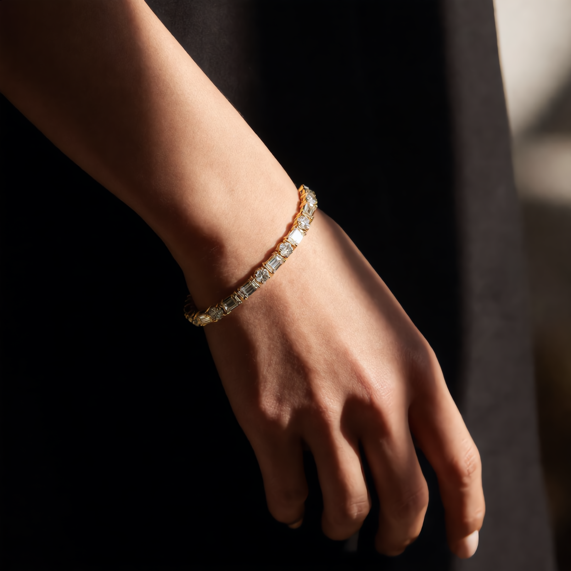 DHARIN Mixed-Cut Tennis Bracelet - lifestyle wrist wearing view, 14K gold, round and emerald-cut diamonds